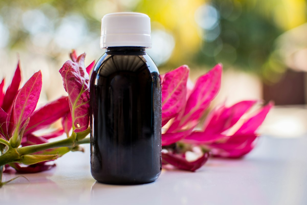 Dark oil in a black glass bottle