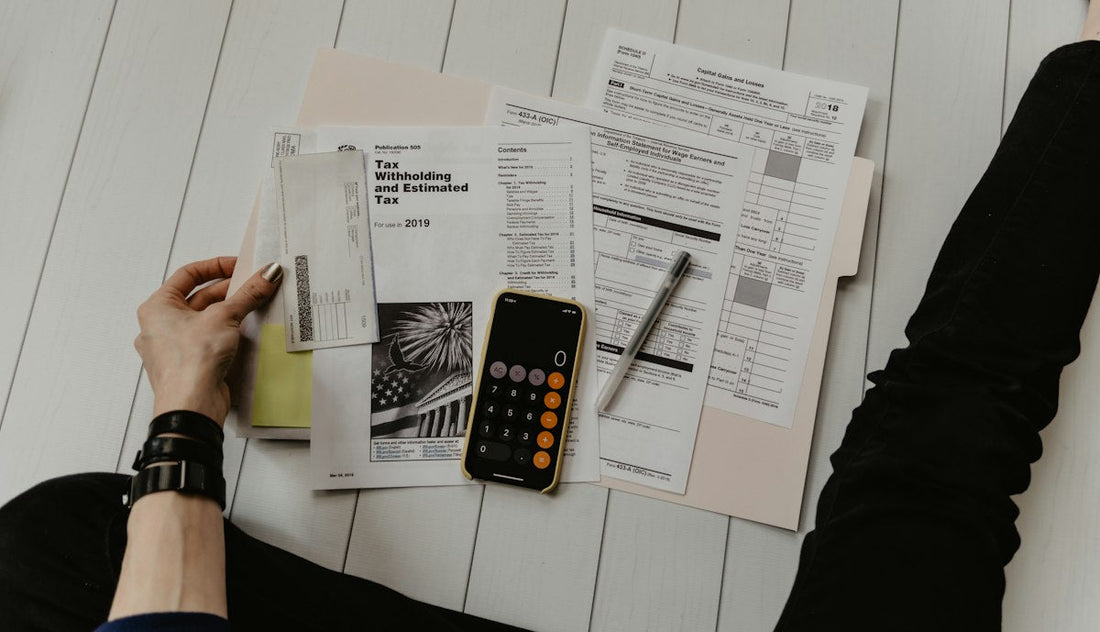 A calculator and tax paperwork on a desk