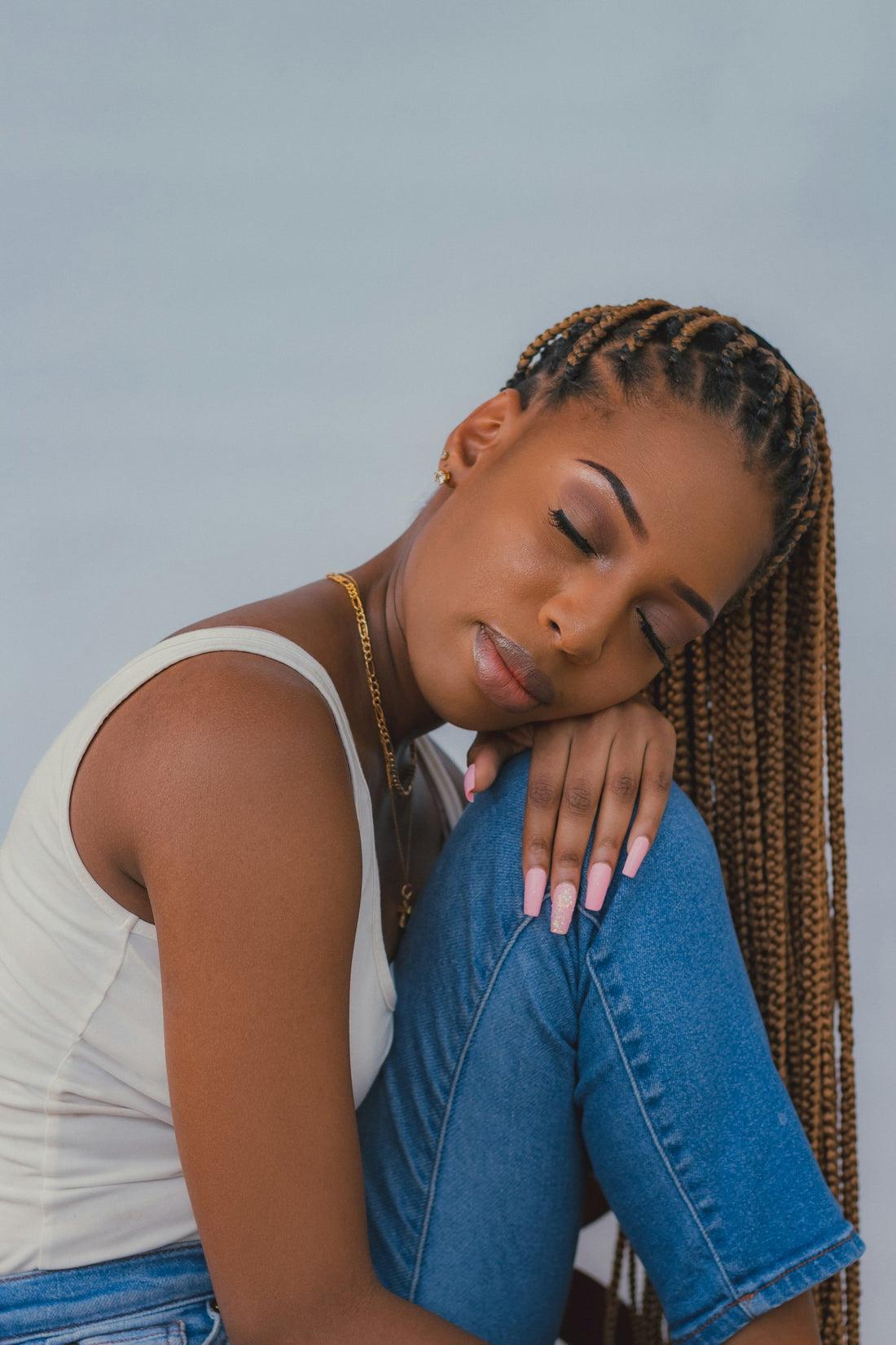 Black woman with long natural hair, eyes closed