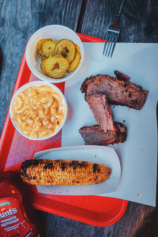 A tray of barbecue with corn and mac and cheese at a Black-owned restaurant in Dallas