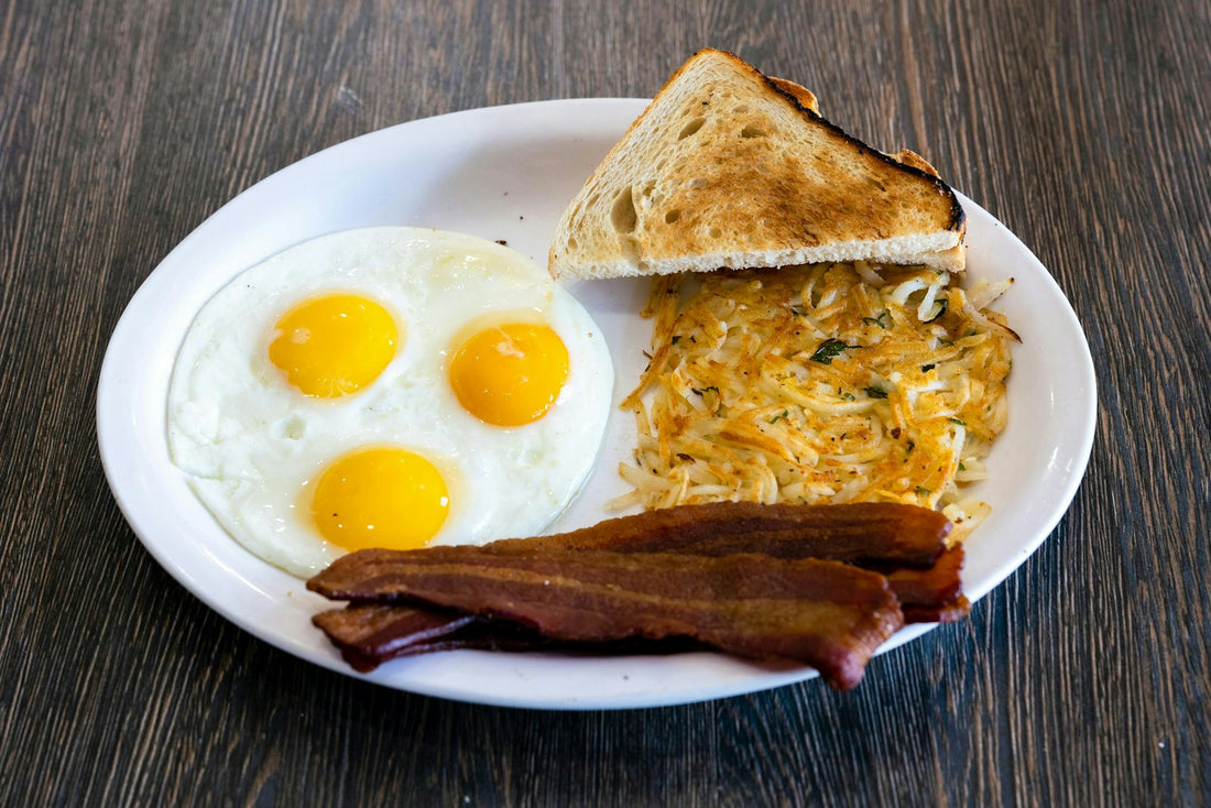 A high-calorie breakfast plate with eggs, bacon and toast