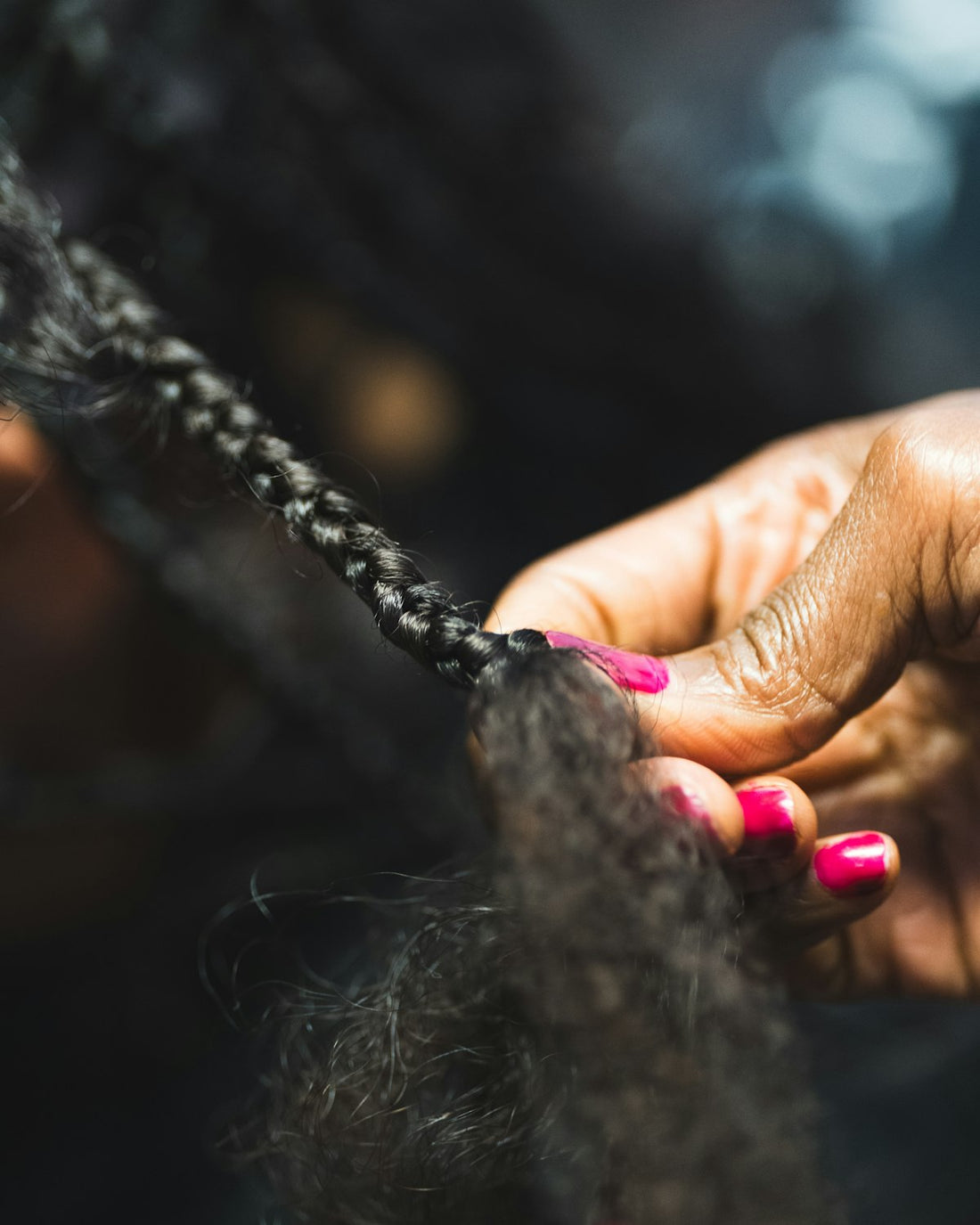 Hands braiding natural hair
