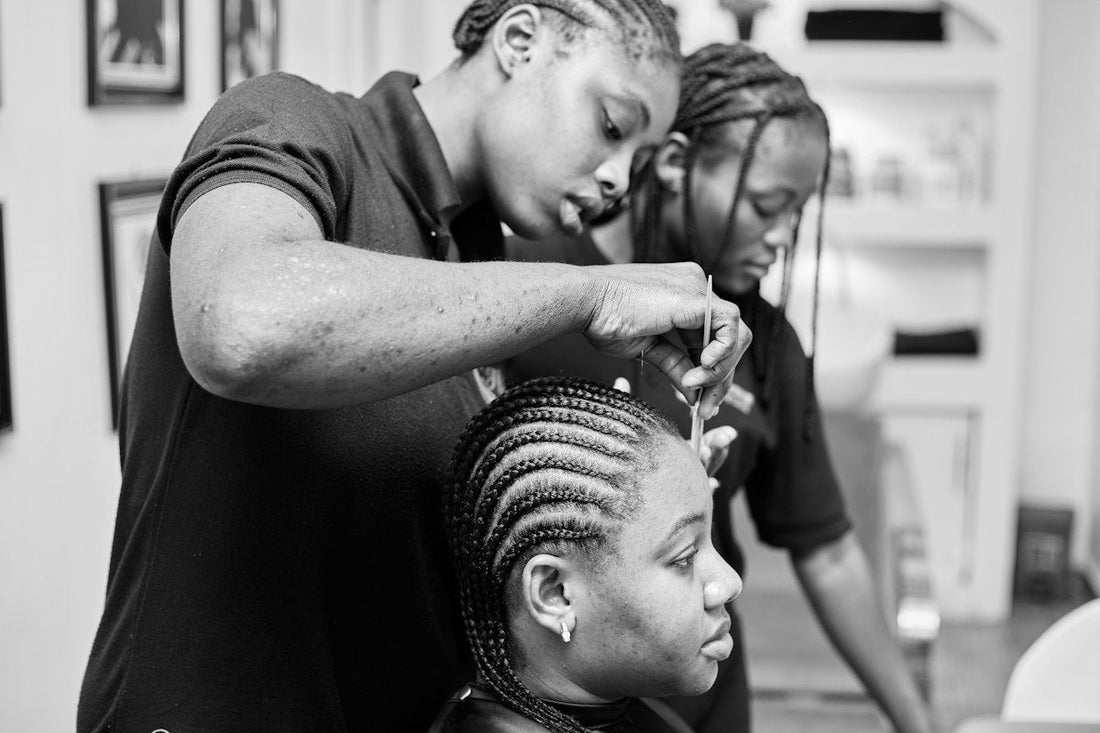A stylist doing natural hair at a Black-owned salon in Detroit