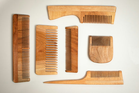Wooden combs on a white surface